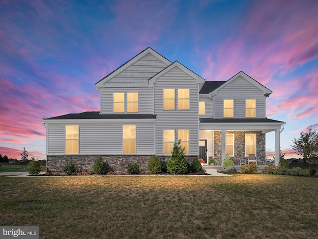 view of front of house featuring a porch and a yard