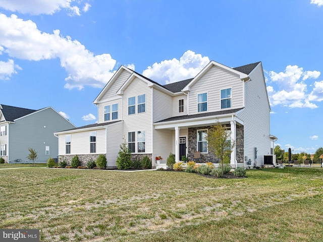 view of front of home with a front yard and covered porch