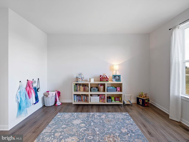 game room with dark hardwood / wood-style flooring