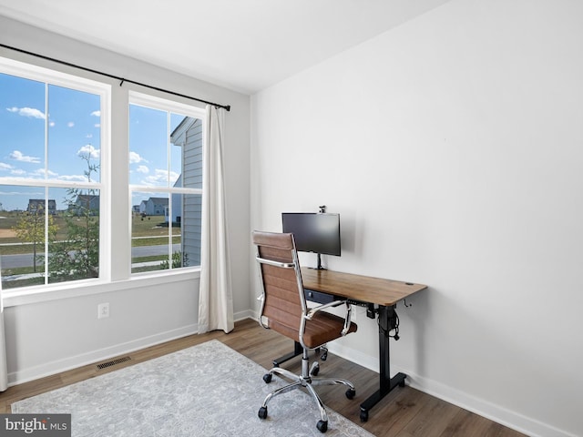 home office with hardwood / wood-style floors