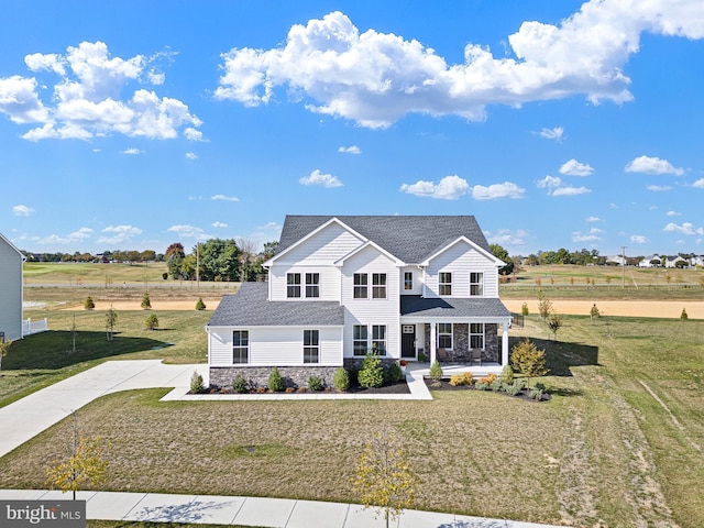 view of front of house featuring a front yard and a rural view