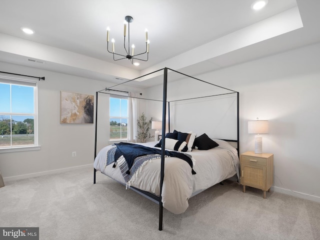 bedroom with light carpet and a notable chandelier