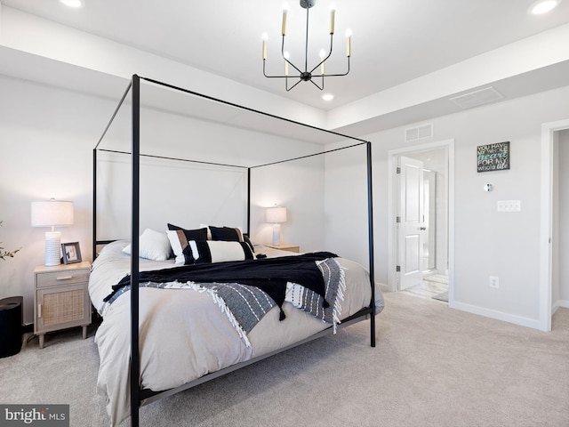 carpeted bedroom featuring an inviting chandelier and connected bathroom