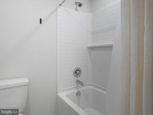 bathroom with shower / bath combo with shower curtain and toilet