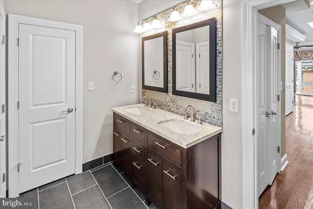 bathroom with vanity, hardwood / wood-style floors, and tasteful backsplash