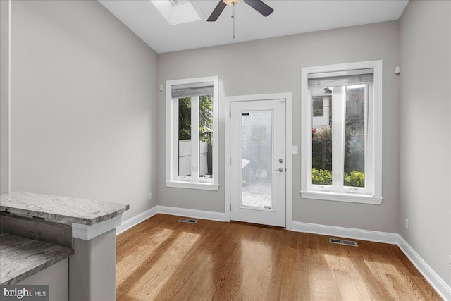 entryway featuring ceiling fan, hardwood / wood-style flooring, and a healthy amount of sunlight