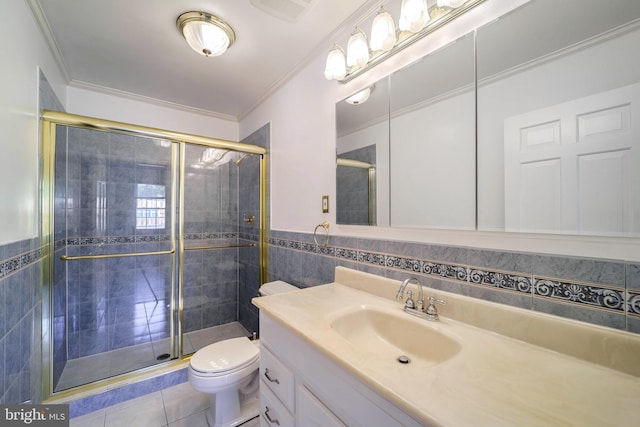 bathroom featuring vanity, a shower with shower door, tile walls, and toilet