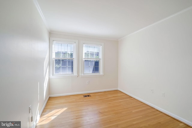 unfurnished room with light hardwood / wood-style flooring and crown molding