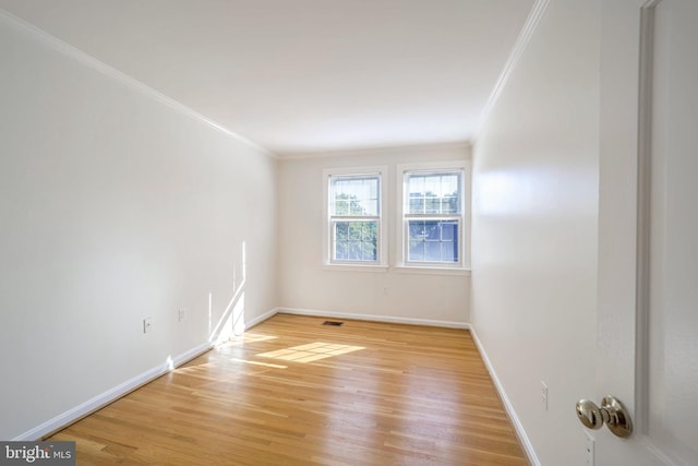 spare room with light hardwood / wood-style floors and ornamental molding