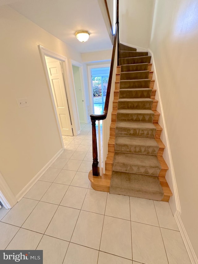 stairs featuring tile patterned flooring