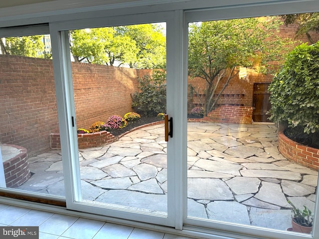 doorway to outside featuring brick wall