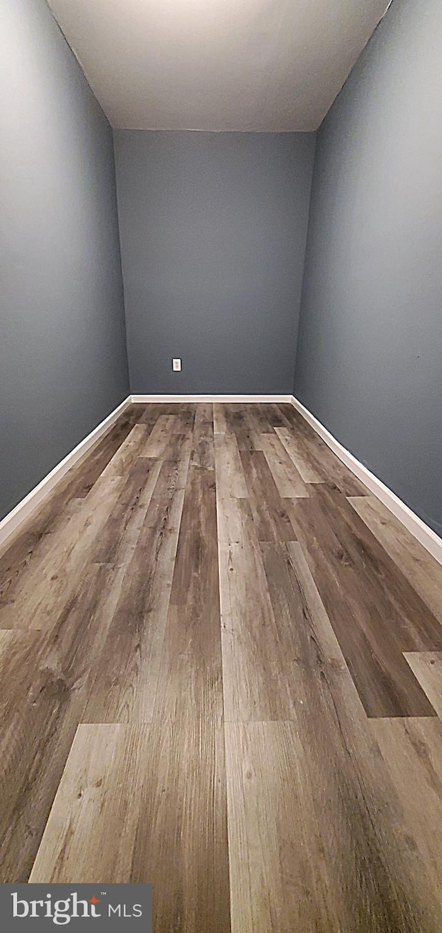 unfurnished room with wood-type flooring