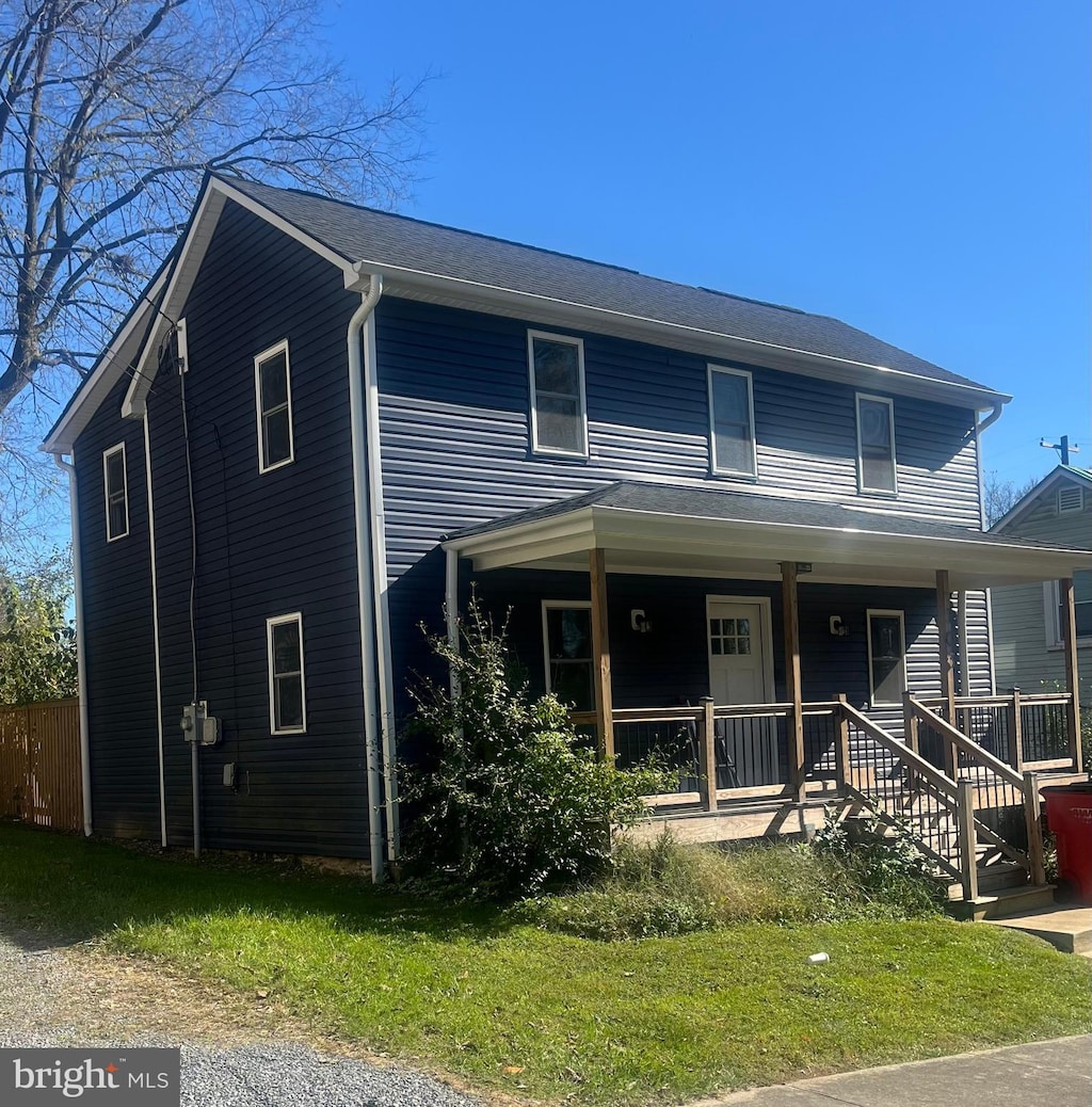 view of front of house with a porch and a front yard