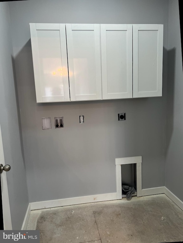 washroom with baseboards, washer hookup, cabinet space, and hookup for an electric dryer