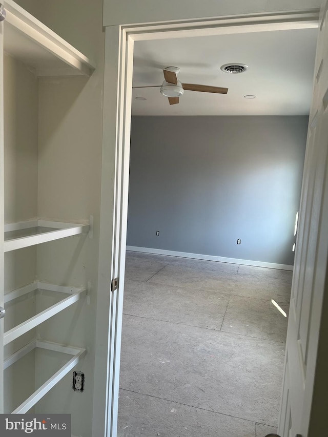 interior space with ceiling fan and visible vents