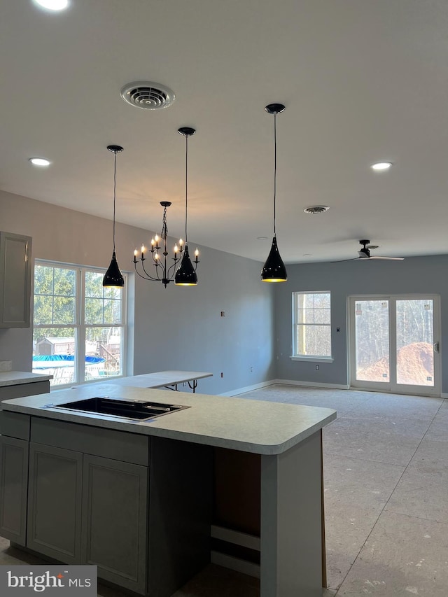 kitchen featuring pendant lighting, light countertops, visible vents, and gray cabinetry