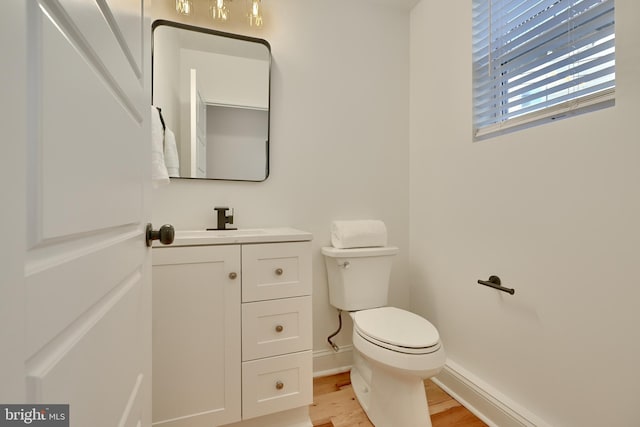 bathroom with vanity, hardwood / wood-style floors, and toilet