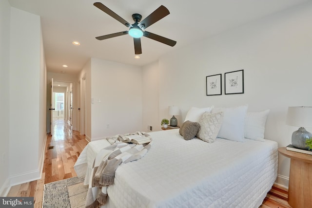 bedroom with light hardwood / wood-style floors and ceiling fan