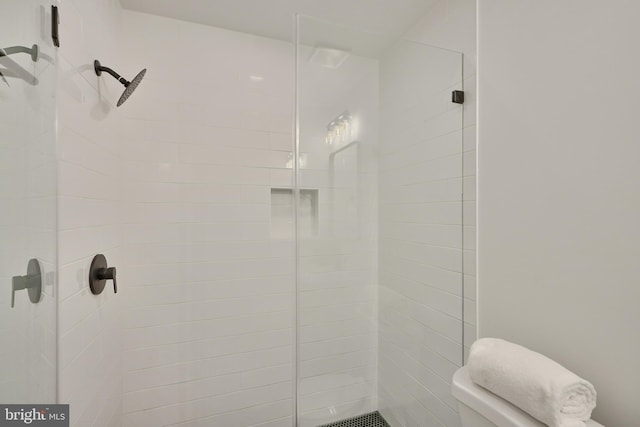 bathroom with tiled shower