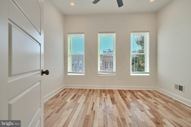 spare room with light hardwood / wood-style floors and ceiling fan