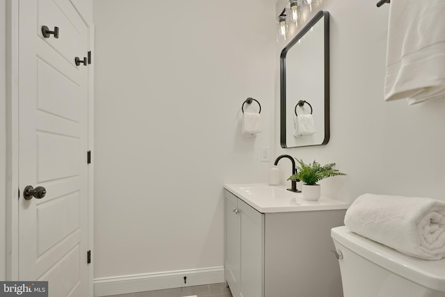 bathroom with vanity, toilet, and tile patterned floors