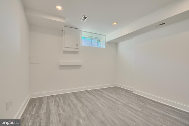 basement with light hardwood / wood-style floors