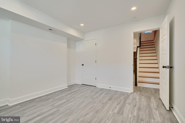 basement with light hardwood / wood-style floors