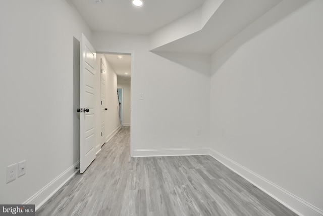 corridor with light hardwood / wood-style floors