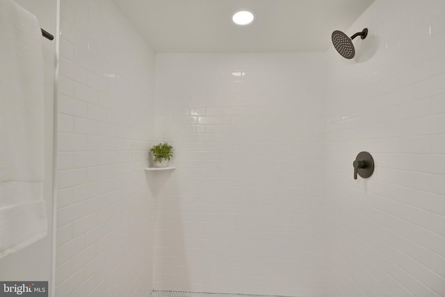 interior details featuring tiled shower