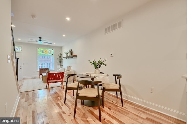 dining area with light hardwood / wood-style flooring and ceiling fan