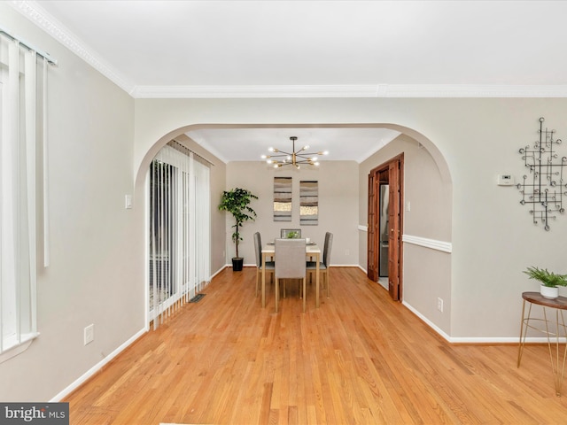 dining area with plenty of natural light, crown molding, a chandelier, and light hardwood / wood-style flooring