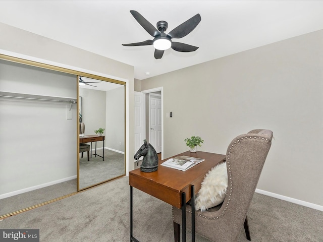 carpeted office space with ceiling fan