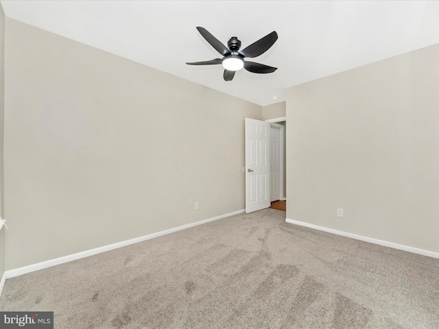 spare room featuring ceiling fan and light colored carpet