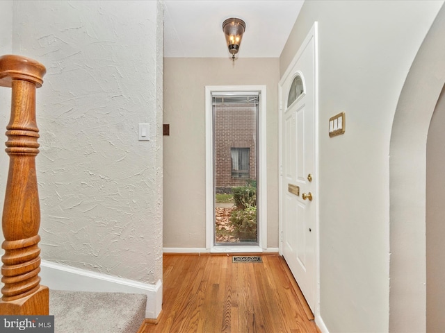 doorway with hardwood / wood-style flooring