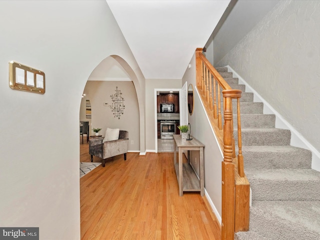 foyer entrance with a fireplace and hardwood / wood-style flooring