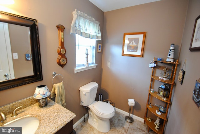 bathroom with vanity, tile patterned flooring, and toilet