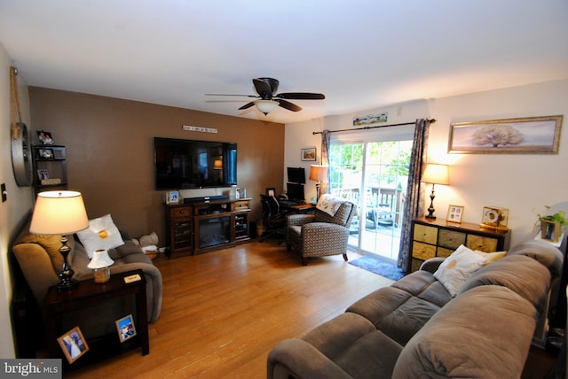 living room with ceiling fan and light hardwood / wood-style flooring