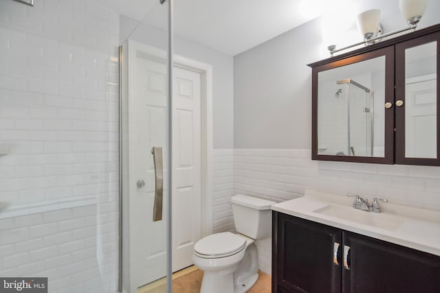 333 Carter Rd, Princeton, NJ 08540 - full bath with vanity, a shower stall, wainscoting, tile walls, and tile patterned floors