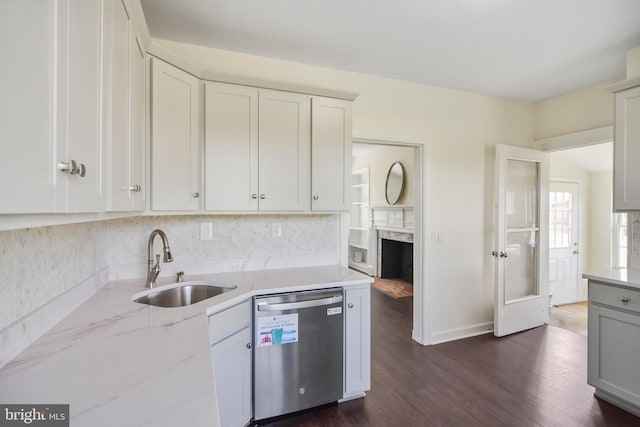 333 Carter Rd, Princeton, NJ 08540 - kitchen with stainless steel dishwasher, dark wood-type flooring, light stone countertops, decorative backsplash, and a fireplace