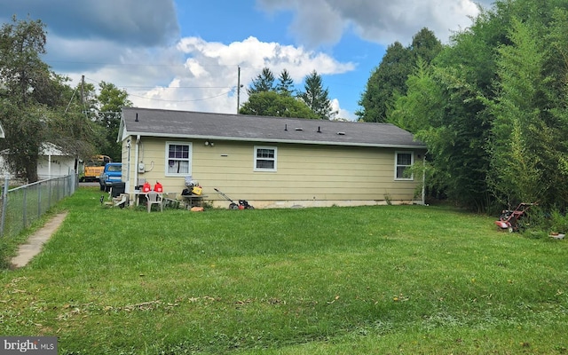 back of property featuring a lawn