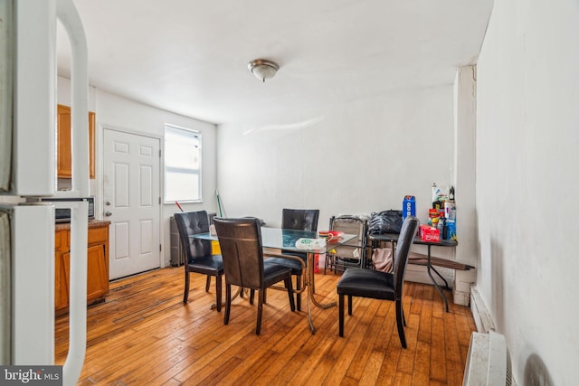 dining area featuring light hardwood / wood-style floors and a baseboard radiator