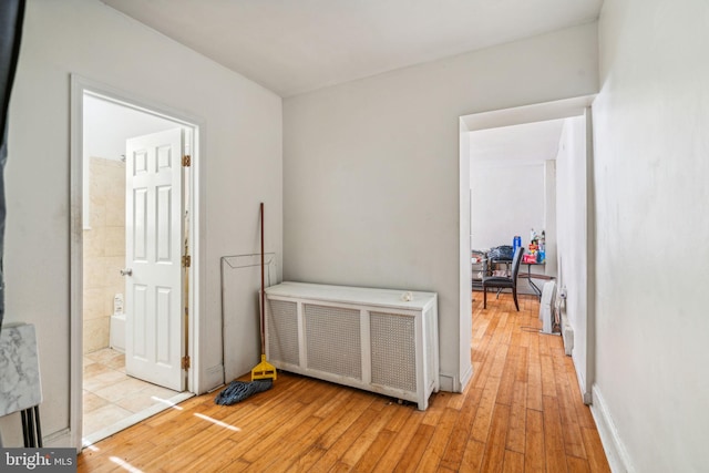 hall featuring radiator heating unit and light wood-type flooring