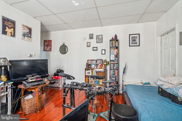 office space featuring a drop ceiling and hardwood / wood-style flooring