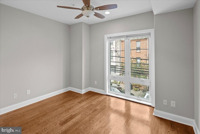 spare room with light hardwood / wood-style flooring and ceiling fan