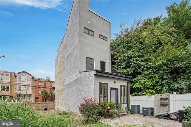 rear view of property featuring central air condition unit