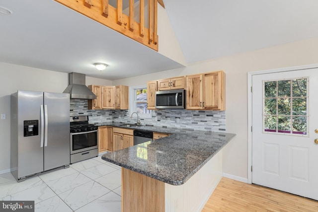273 Four Seasons Dr, Drums, PA 18222 - kitchen with dark stone countertops, a peninsula, wall chimney exhaust hood, appliances with stainless steel finishes, and a sink