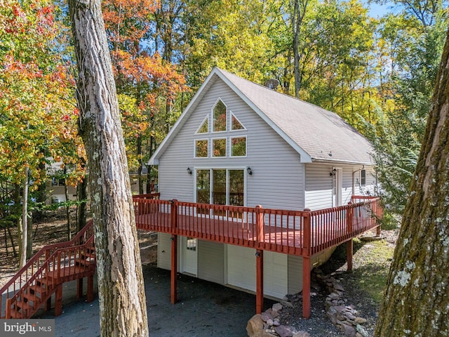 273 Four Seasons Dr, Drums, PA 18222 - rear view of house featuring a wooden deck, a shingled roof, and a garage