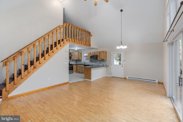 273 Four Seasons Dr, Drums, PA 18222 - interior space featuring stairway, high vaulted ceiling, light wood finished floors, a baseboard radiator, and a sink