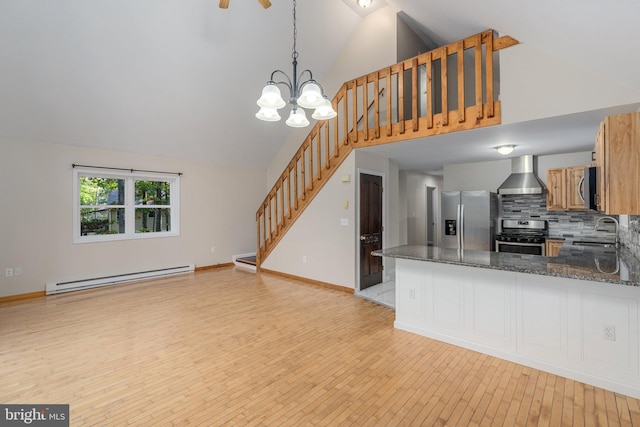 273 Four Seasons Dr, Drums, PA 18222 - kitchen featuring light wood-style flooring, wall chimney exhaust hood, stainless steel appliances, a baseboard radiator, and a sink