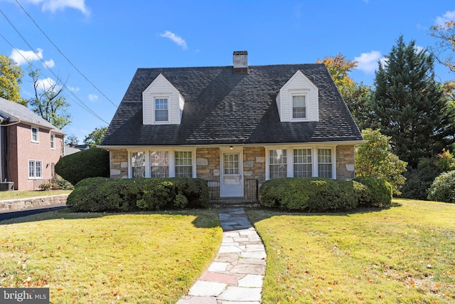 cape cod house with a front lawn